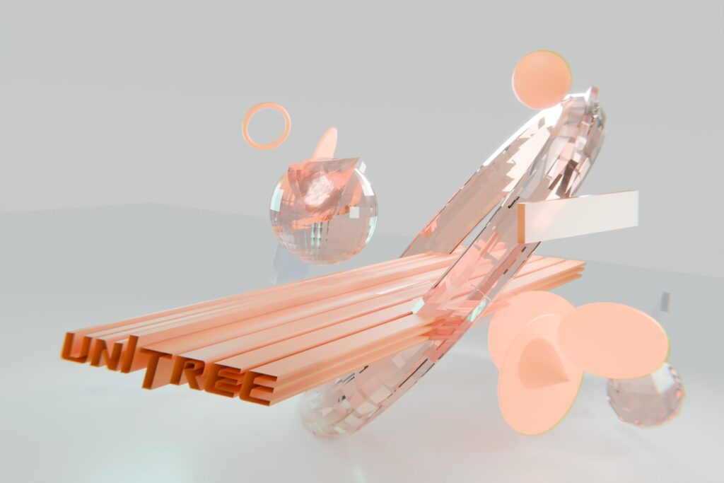Unitree text on a wooden surface with abstract orange shapes.