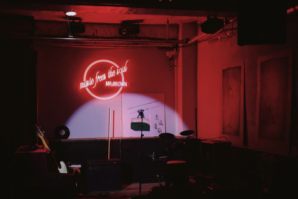 a stage set up for a concert with a neon sign