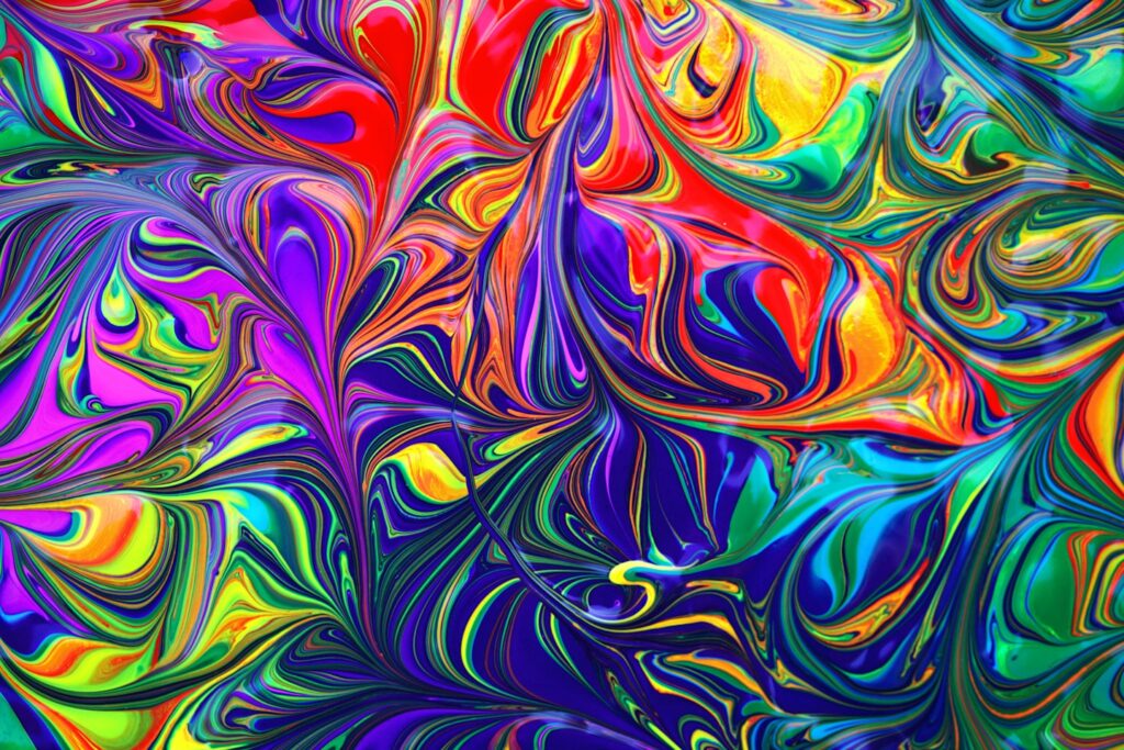 Psychedelic colorful rainbow paint wallpaper background.